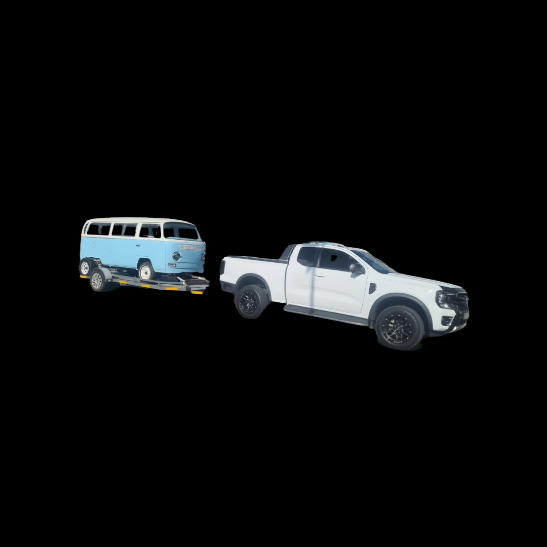 White pickup truck towing another vehicle — vehicle transport or recovery service