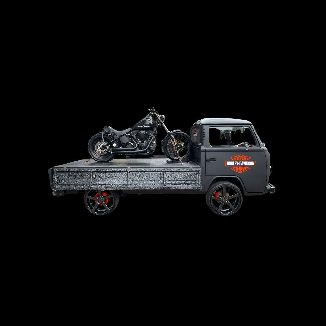Black pickup truck carrying motorcycle on flatbed — versatile transport solution